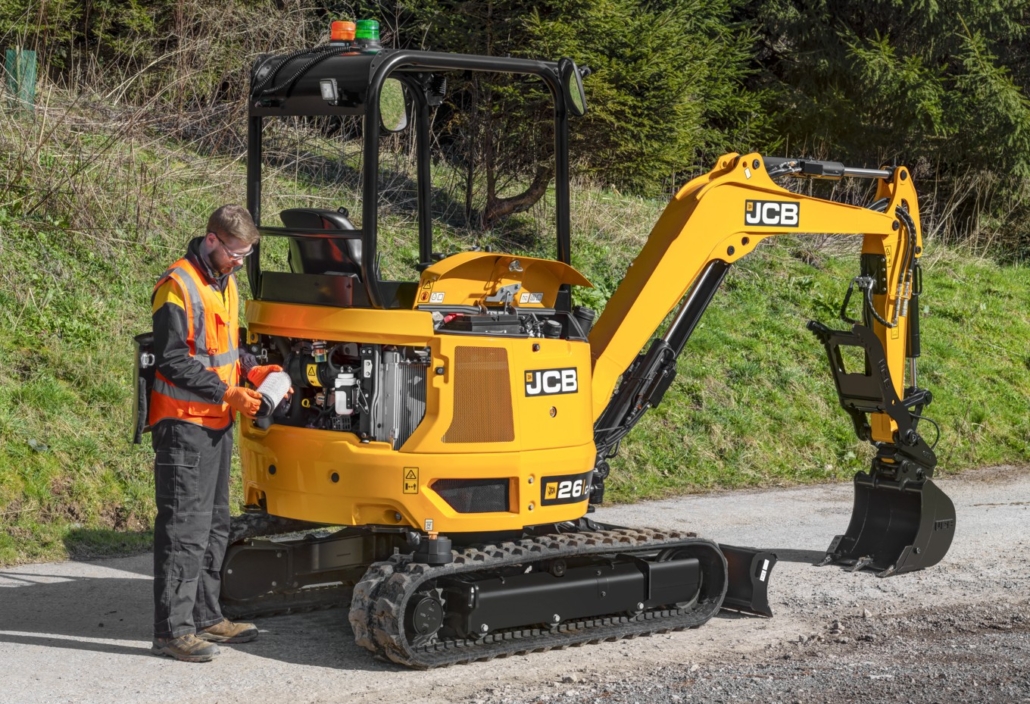 Image shows an engineer checking the oil filter on a JCB 26C Mini Excavator digger