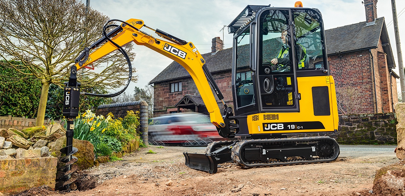 JCB 19C mini excavator drilling into the ground