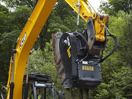 an excavator with a large attachment on it
