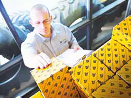 a parts advisor getting a box of parts off the shelf