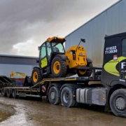 JCB Telehandler signwritten for FGS on the back of a lorry