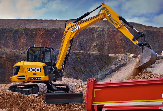 100C-2 Mini Excavator loading a truck with material