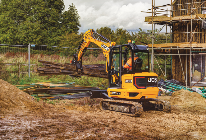 JCB 35Z Mini Excavator lifting a pile of wood with a grab