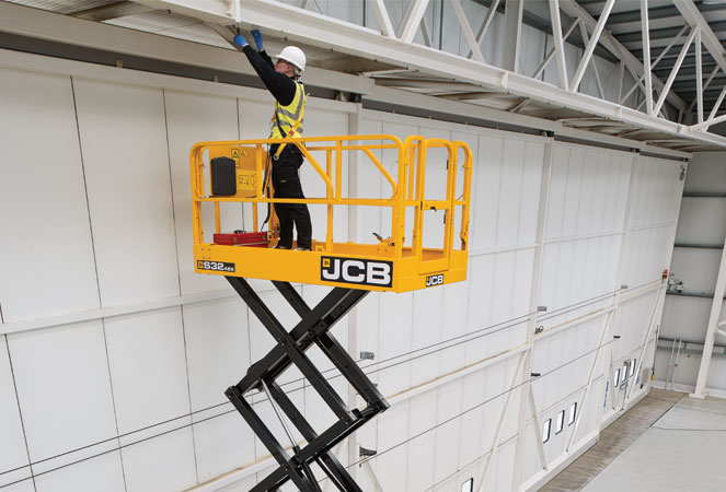 JCB S3246E Access Platform in a warehouse fixing the ceiling