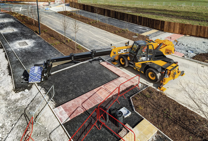 A JCB 555-210R Rotating Telehandler with its boom extending out across fresh tarmac