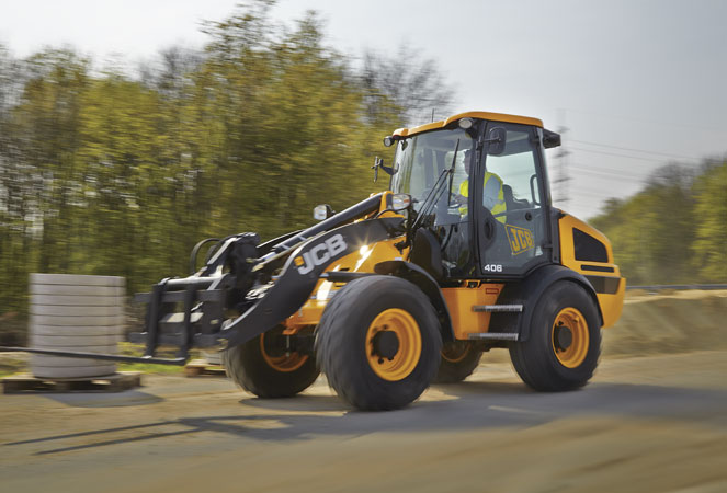 A 406 Wheel Loading Shovel traveling along