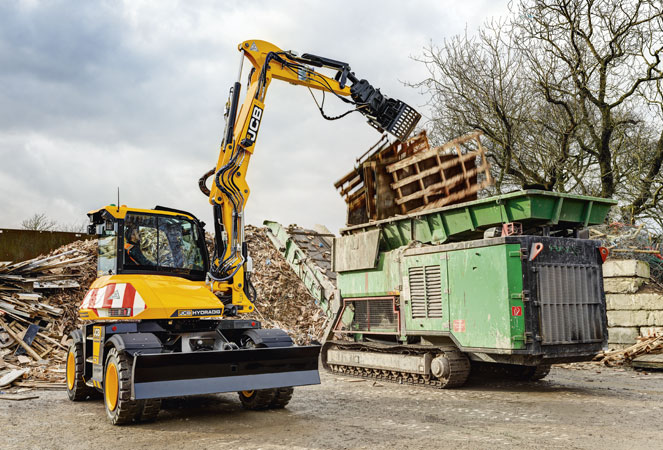 JCB Hydradig 110W Wheeled Excavator putting pallets into a skip