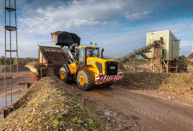 A 427 Wheel Loading Shovel with its shovel in the air
