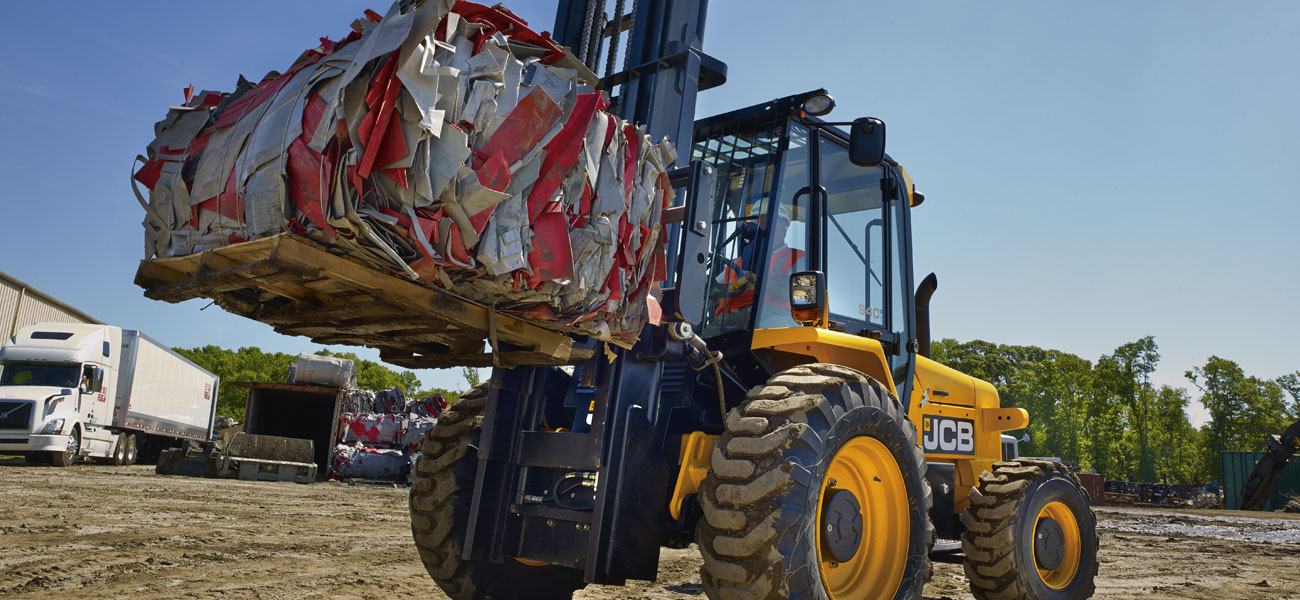 JCB Rough Terrain Forklift carrying compacted metal