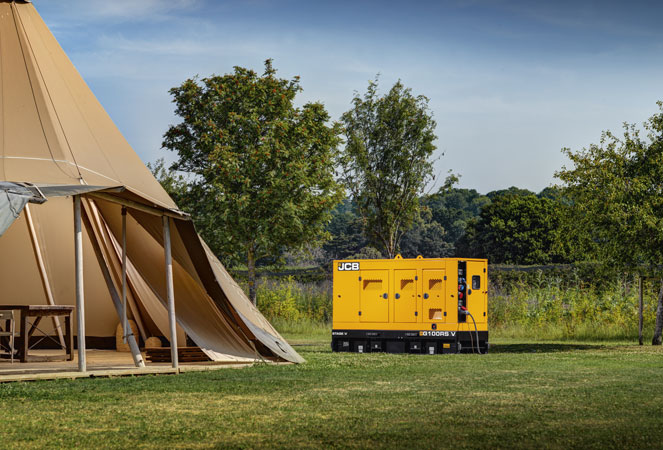 JCB G100RS next to a large tent
